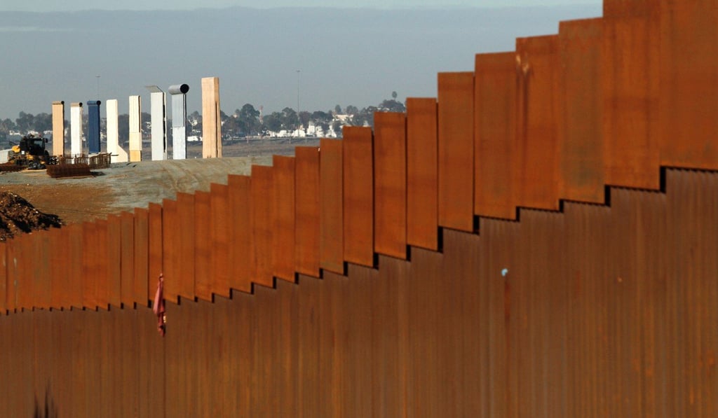 The prototypes for US President Donald Trump's border wall are seen behind the border fence between Mexico and the US. The US government has been shut down by a dispute over funding for the wall. Photo: Reuters