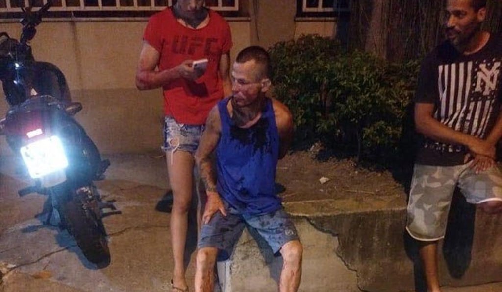 Polyana Viana stands behind her would-be mugger. Photo: Twitter