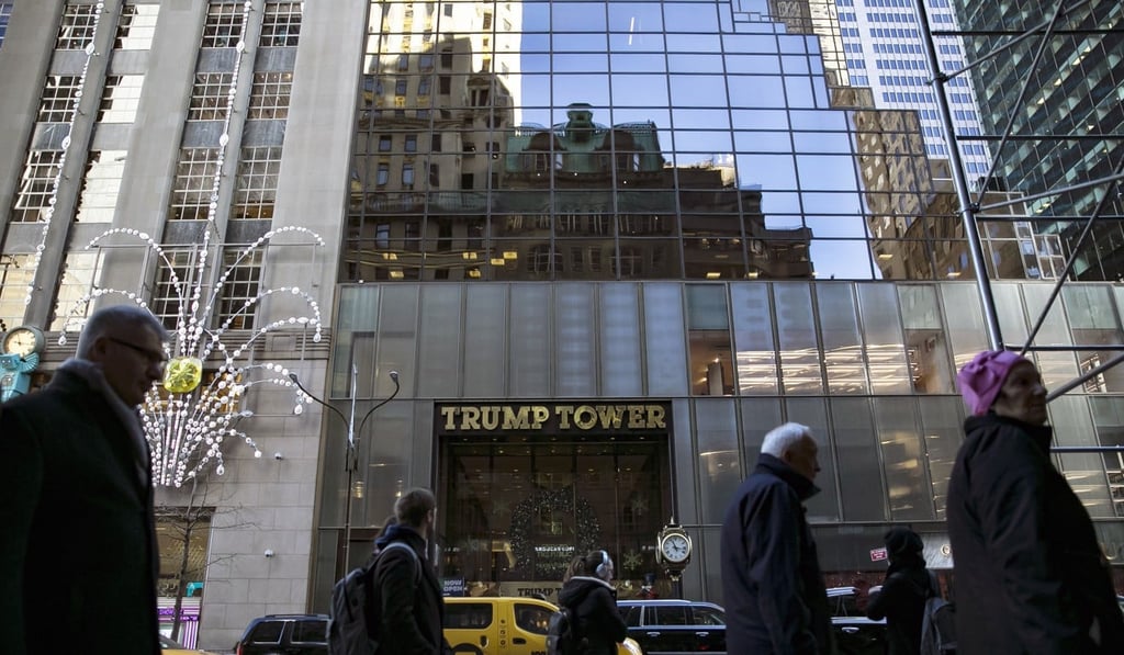 Pedestrians pass in front of Trump Tower in New York in December. Photo: Allison Joyce/Bloomberg