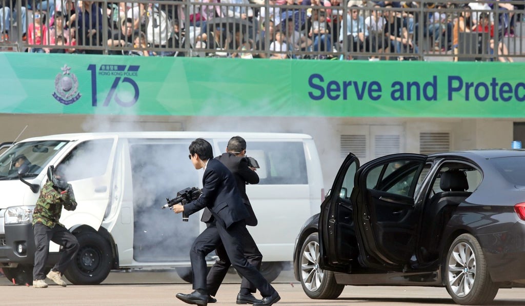 Spectators watch a staged event demonstrating police skills. Photo: Dickson Lee
