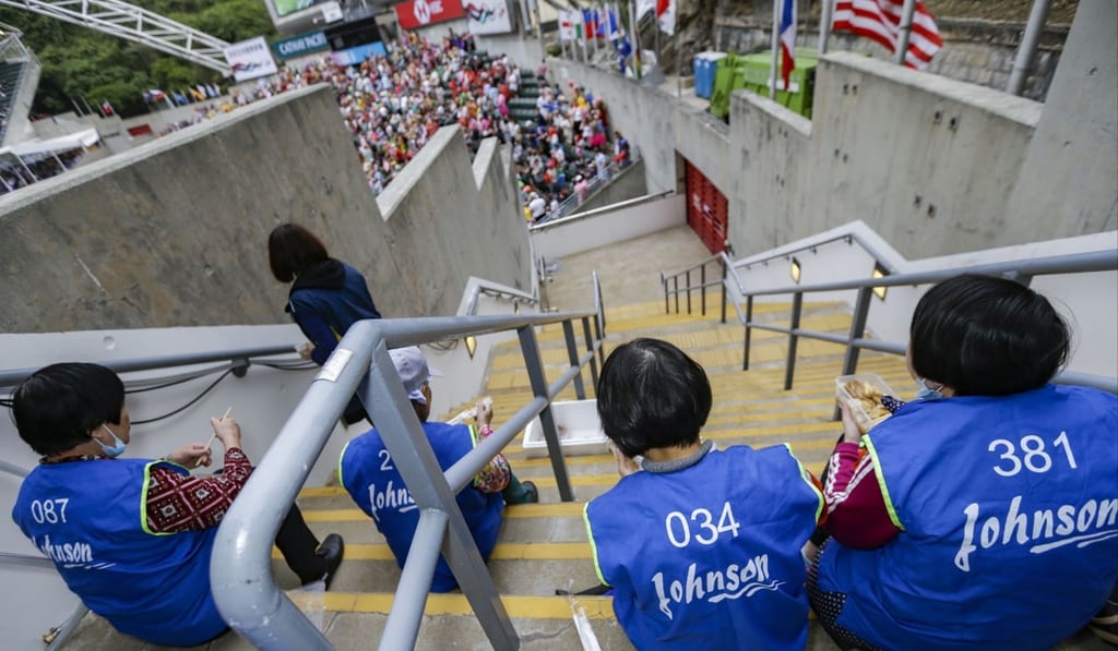 Cleaners take a break during the second day of the Hong Kong Sevens at Hong Kong Stadium on April 7, 2018. Photo: May James