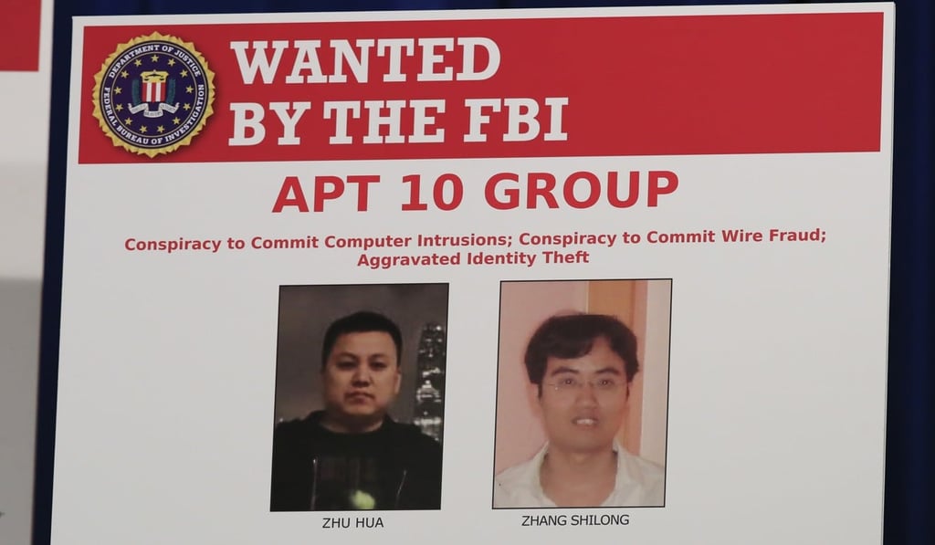 A poster displayed during a news conference at the Department of Justice in Washington on December 20, 2018, shows two Chinese citizens suspected to be with the group APT 10 carrying out an extensive hacking campaign to steal data from US companies. Photo: AP