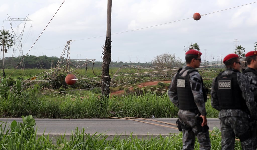 Riot police stand next to the site where a power transmission tower was damaged by a bomb in the outskirts of Fortaleza, Brazil, January 12, 2019. Photo: Reuters