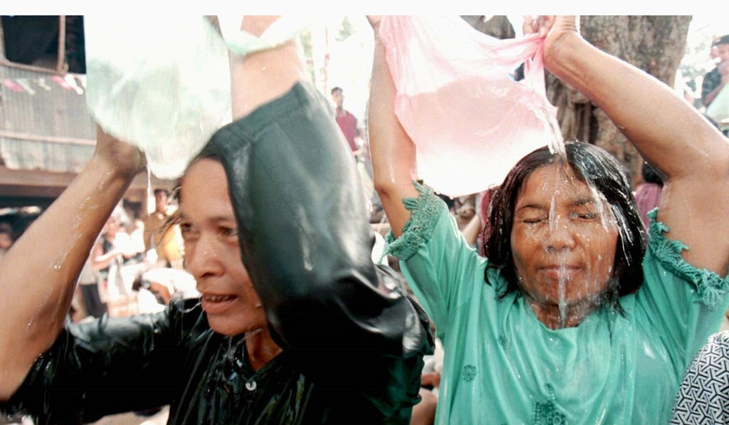 Cambodian women pour water from a magic turtle they believe has special powers near Prek Kdam village, 50km north of Phnom Penh. Hundreds of people flock to the small village each day to get some of the water in which the turtle has been immersed, in the belief it has special healing powers. Photo: Reuters