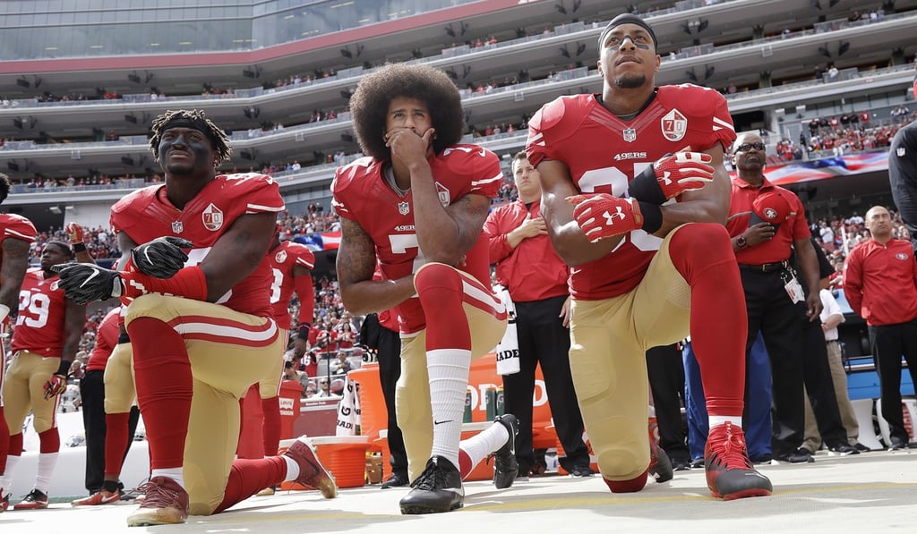San Francisco 49ers outside linebacker Eli Harold, quarterback Colin Kaepernick and safety Eric Reid kneel during the national anthem before a game in October 2016. The act of protest ignited a national conversation on anthem etiquette. Photo: AP