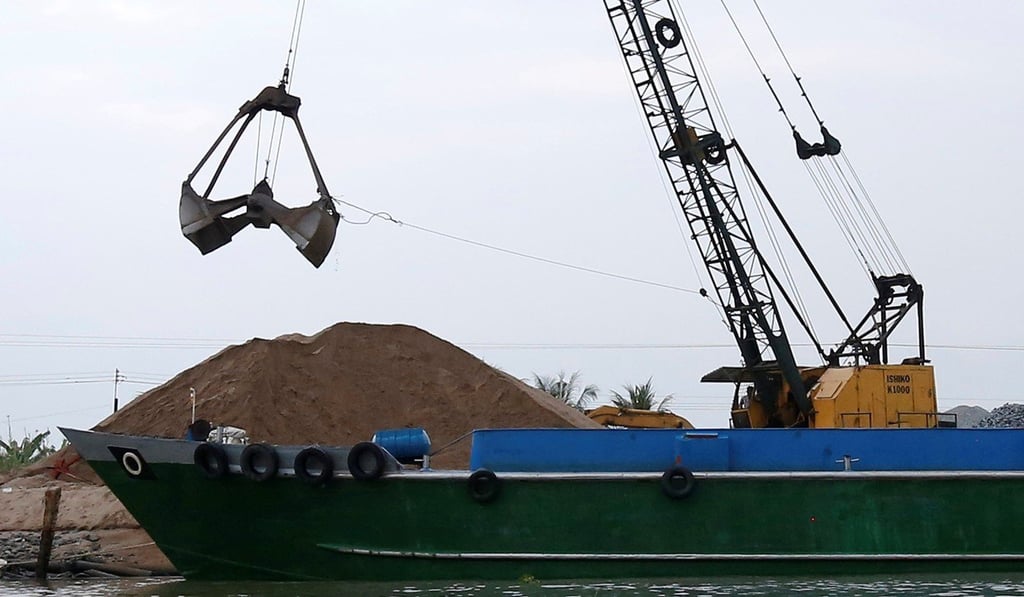 A crane moves sand from a ship on Mekong river in Hau Giang province, Vietnam. Photo: Reuters