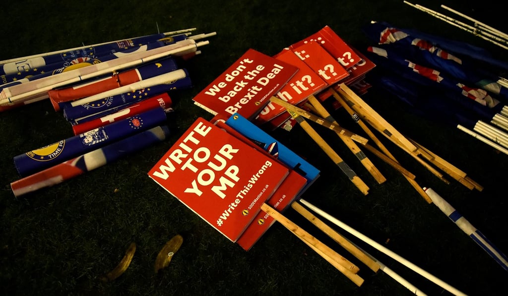 Anti-Brexit signs are seen outside the Houses of Parliament in London on Tuesday. Photo: Reuters