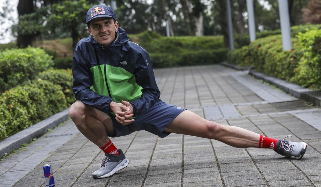 Dylan Bowman stretches in Victoria Park. Ultra running is the perfect blend of competition and community. Photo: K.Y. Cheng