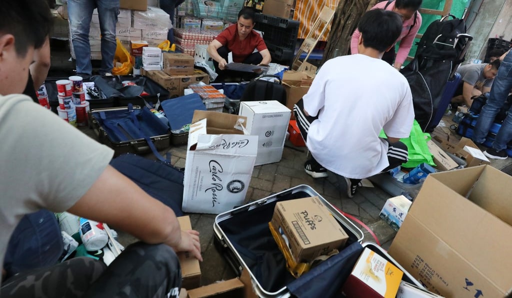 Parallel traders seen packing goods on a street in Sheung Shui. Photo: Felix Wong