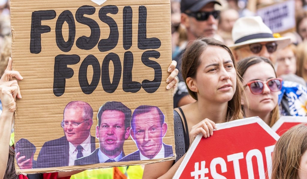 People protest during a demonstration demanding action on climate change and a stop to the Adani coal mining project in Queensland, outside Queensland Parliament House in Brisbane, Australia. Photo: EPA