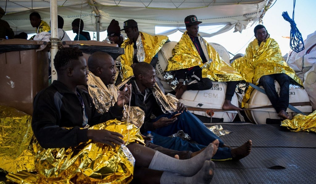 Migrants wrapped in survival blankets aboard the Dutch-flagged vessel Sea Watch 3 after being rescued from an inflatable boat. Photo: AFP
