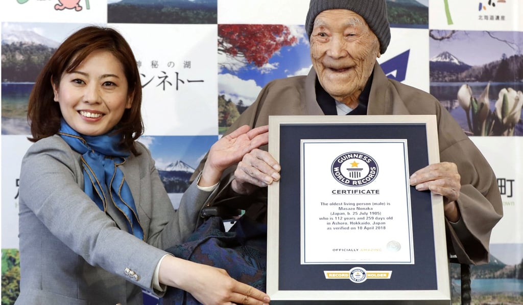 Nonaka holding his framed certificate from Guinness World Records on April 10, 2018. Photo: Kyodo/Reuters