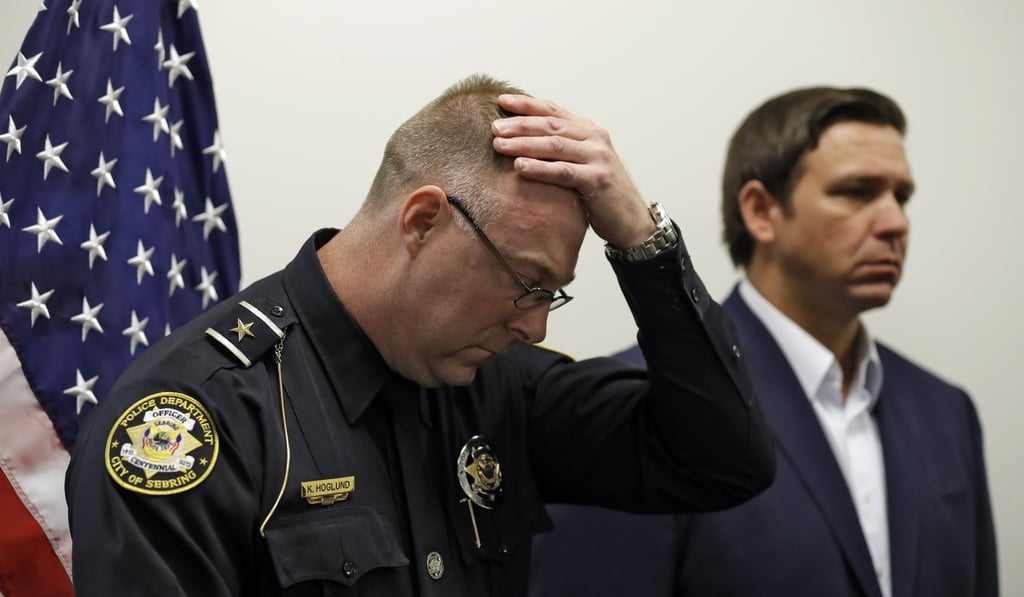 Sebring police chief Karl Hoglund wipes his head as he attends a news conference with Florida Governor Ron DeSantis on Wednesday to discuss the killing of five people in a SunTrust bank branch. Photo: AP