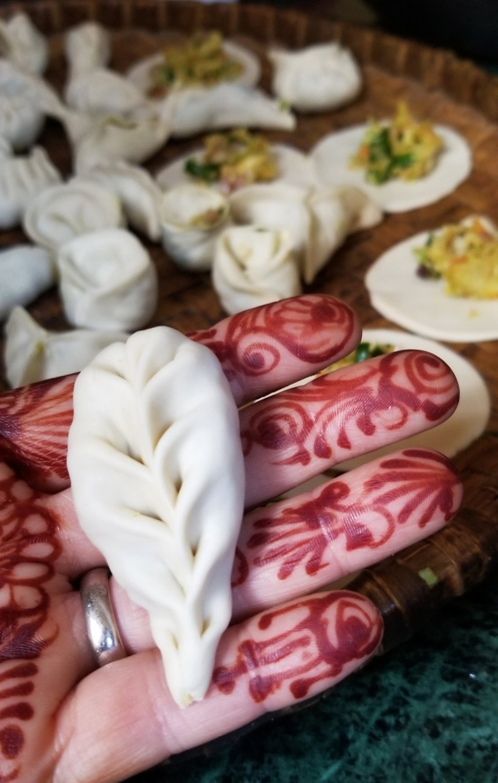 In the momo-making class, Julie Lopez shows off her dumpling folding skills. Photo: Julie Lopez for The Washington Post In the momo-making class, Julie Lopez shows off her dumpling folding skills. Photo: Julie Lopez for The Washington Post