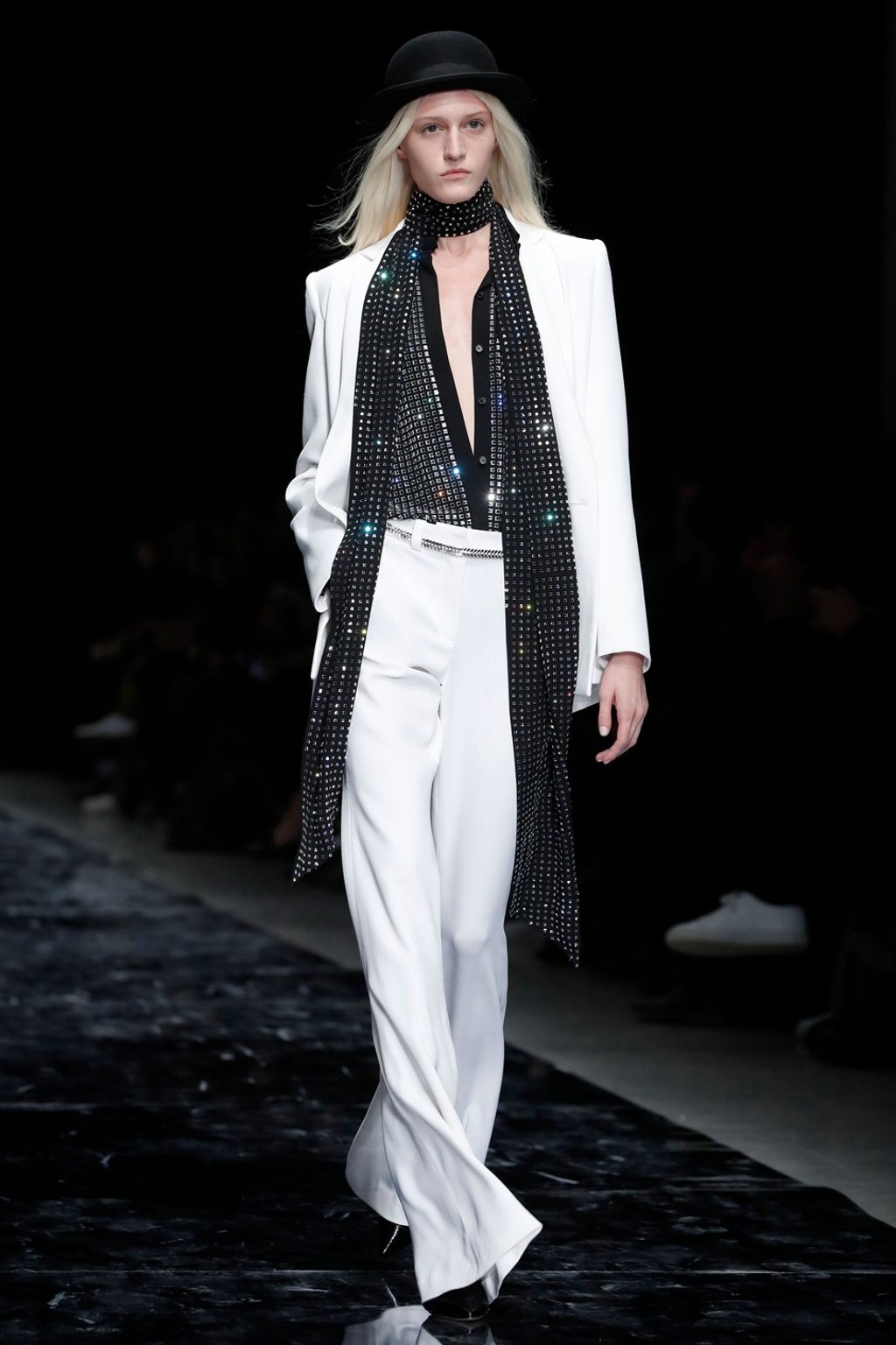 A model presents creations, including a white trouser suit, by Azzaro Couture during the 2019 spring/summer haute couture collection show in Paris. Photo: AFP