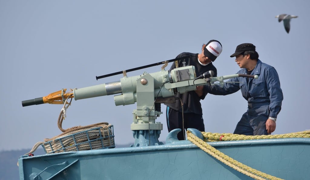 The crew of a whaling ship check a whaling gun or harpoon before departing Japan’s Ayukawa port. Photo: AFP