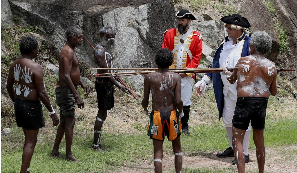Members of the Guguyimithirr tribe re-enact the landing of Captain Cook in 1788. Photo: EPA Members of the Guguyimithirr tribe re-enact the landing of Captain Cook in 1788. Photo: EPA
