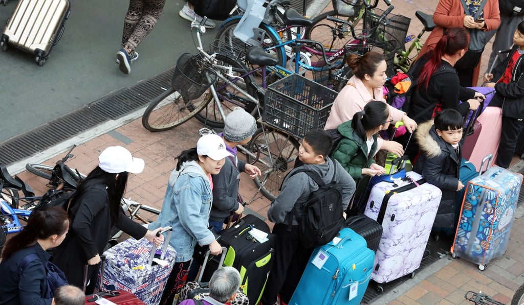 Mainlanders with suitcases in Sheung Shui. Photo: Nora Tam