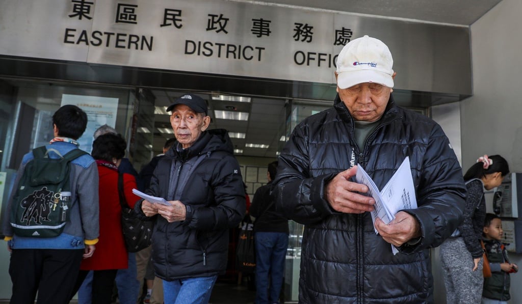 People collect application forms for the Caring and Sharing Scheme. Photo: Sam Tsang