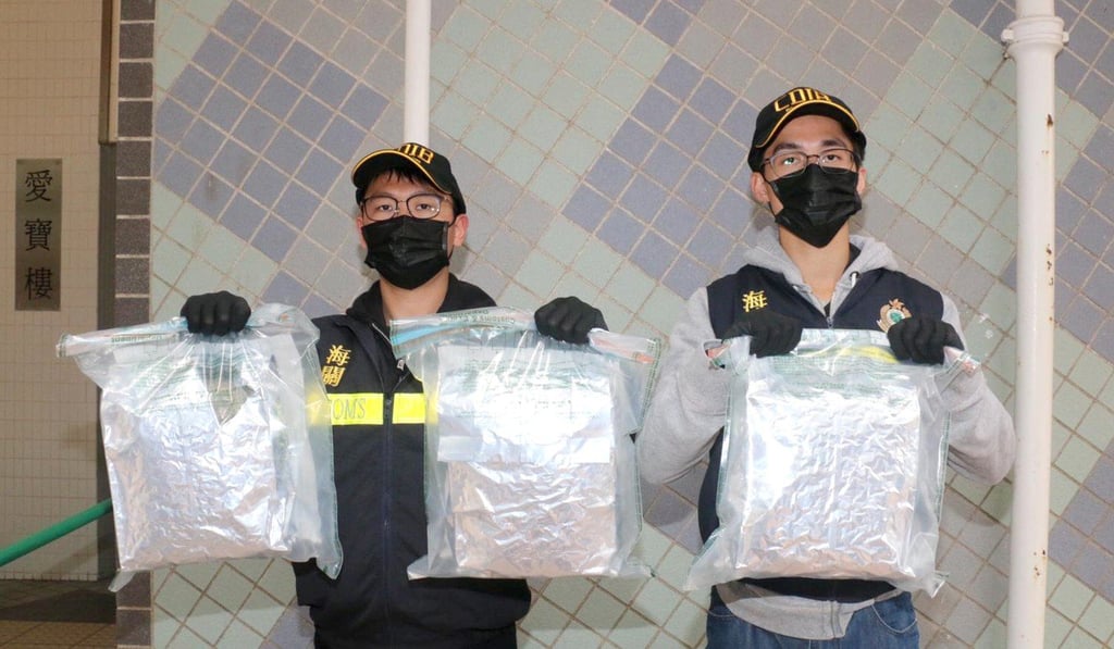 Customs officers with the bags of drugs seized at the Lok Ma Chau checkpoint. Photo: handout