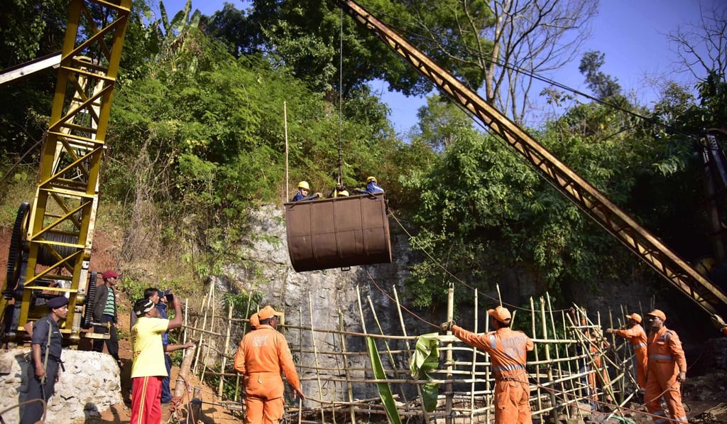 Rescuers gather around a crane while Indian Navy divers are lifted with a pulley during rescue operations after 15 miners were trapped by flooding in an illegal coal mine in Ksan village in Meghalaya's East Jaintia Hills district. Photo: AFP Rescuers gather around a crane while Indian Navy divers are lifted with a pulley during rescue operations after 15 miners were trapped by flooding in an illegal coal mine in Ksan village in Meghalaya's East Jaintia Hills district. Photo: AFP