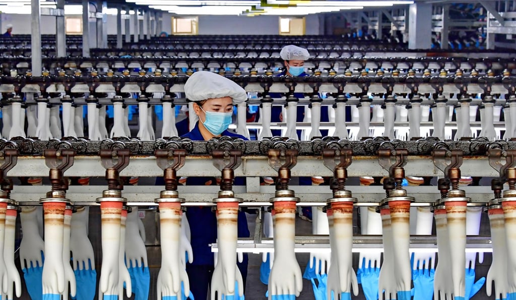 Workers produce gloves at a factory in Luannan county in north China’s Hebei province in November 2018. Over 13 billion gloves for medical use are produced in the county and exported to markets including the US, Germany and France, but a strengthening yuan versus the euro in addition to the US dollar could hit demand for Chinese products. Photo: Xinhua