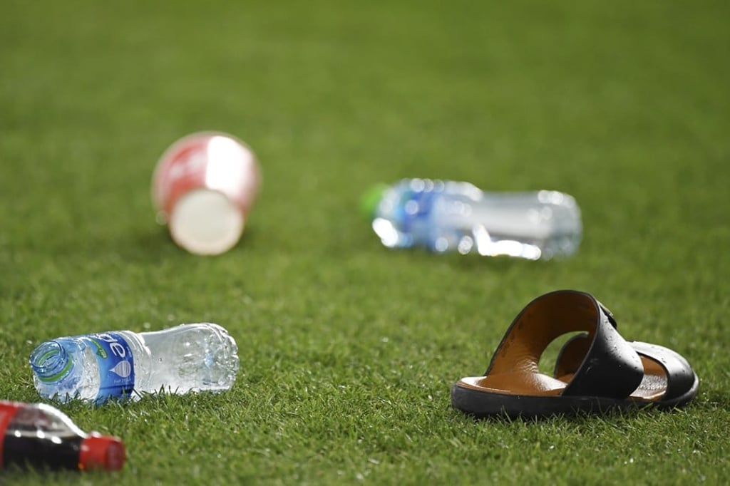 A shoe and bottles that where thrown by UAE fans rest on the pitch during the AFC Asian Cup semi-final between UAE and Qatar. Photo: AP A shoe and bottles that where thrown by UAE fans rest on the pitch during the AFC Asian Cup semi-final between UAE and Qatar. Photo: AP