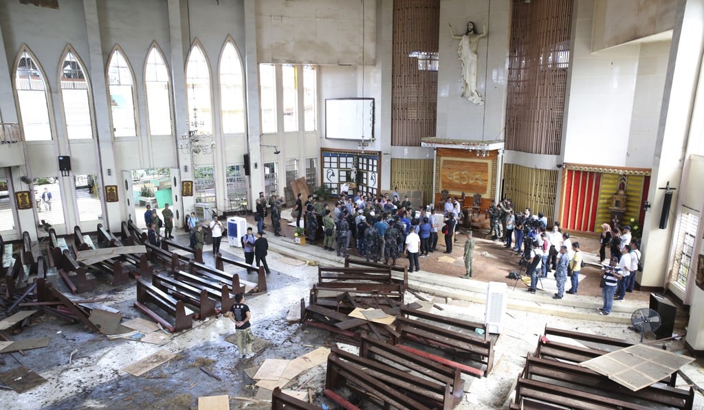 The damaged church inspected by Philippine President Rodrigo Duterte in Jolo. Photo: EPA The damaged church inspected by Philippine President Rodrigo Duterte in Jolo. Photo: EPA