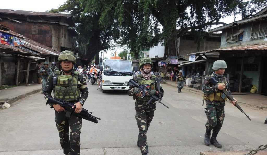 Philippine soldiers escorting a hearse during the funeral procession of a victim killed in the January 27 cathedral bombing in Jolo. Photo: AFP