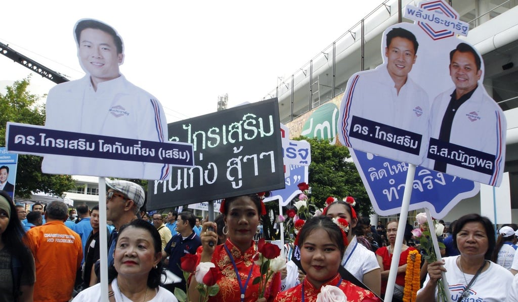 Supporters of pro-junta party Palang Pracharath hold election campaign banners during candidate registration. Photo: EPA Supporters of pro-junta party Palang Pracharath hold election campaign banners during candidate registration. Photo: EPA