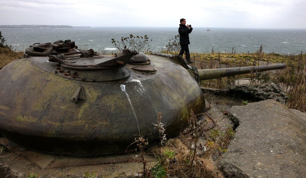 Russian president at the time, Dmitry Medvedev, walks near Soviet-era fortifications during his visit to one of the Kuril islands in 2010. Photo: AFP