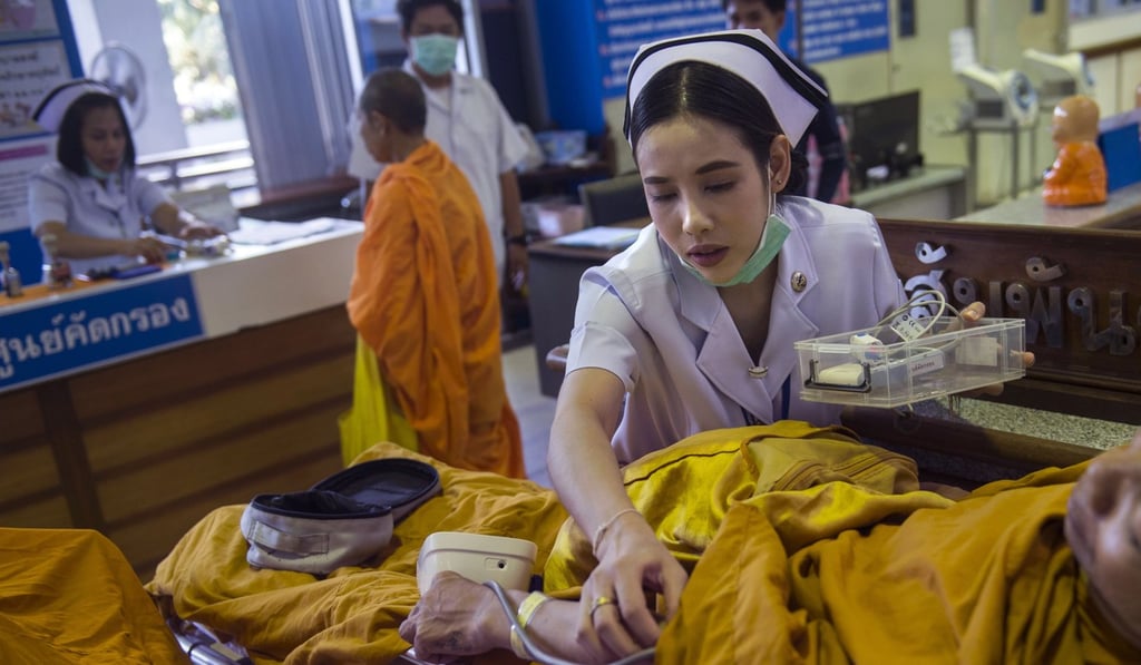 A nurse checking the blood pressure of a patient at a government-run hospital for Buddhist monks in Bangkok. Followers have been showering monks, who are deeply respected in Thailand, with foods loaded with sugar, fat and oil, contributing to a brewing health crisis. Photo: AFP