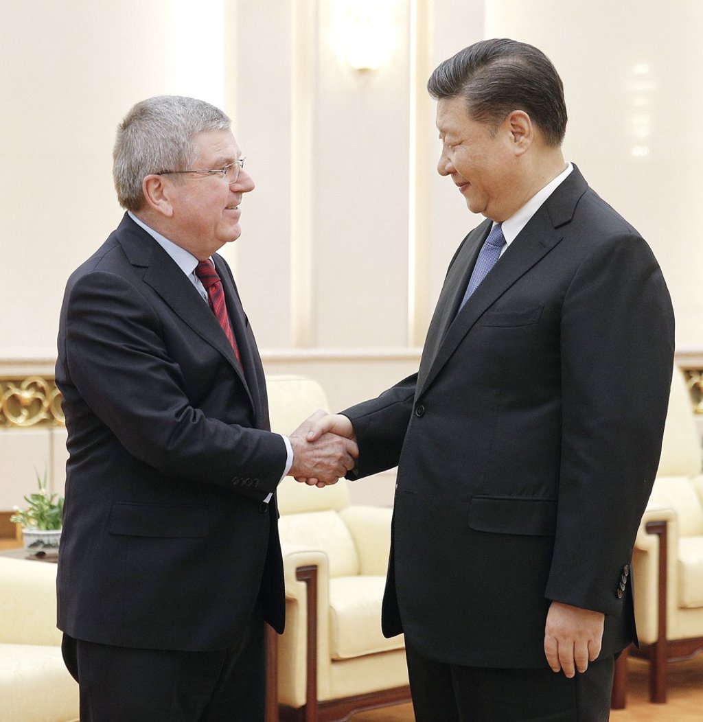 International Olympic Committee President Thomas Bach (left) and Chinese President Xi Jinping shake hands before their talks at the Great Hall of the People in Beijing on January 31. Photo: Kyodo