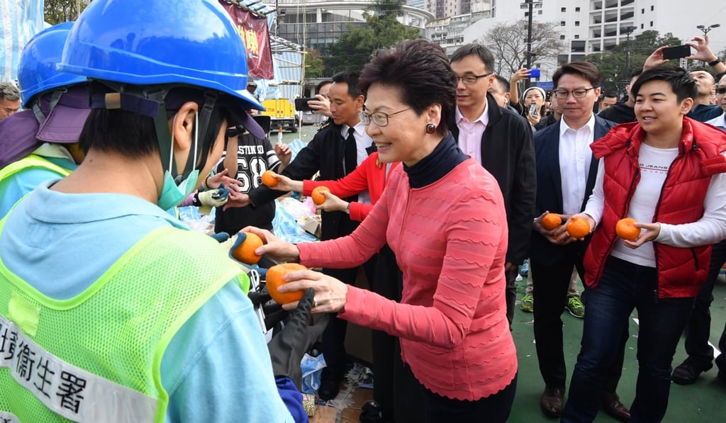 Carrie Lam hands out gifts to workers after the Lunar New Year market. Photo: Handout Carrie Lam hands out gifts to workers after the Lunar New Year market. Photo: Handout