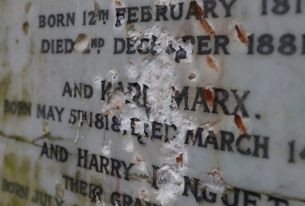 The marble plaque that has been defaced by vandals. Photo: Reuters