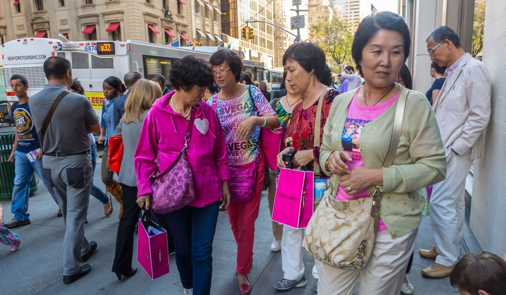 Chinese tourists on Fifth Avenue in Manhattan. Photo: Alamy Chinese tourists on Fifth Avenue in Manhattan. Photo: Alamy
