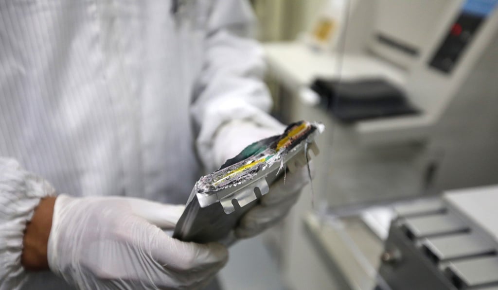 A GRST worker with a disassembled battery. Photo: Xiaomei Chen