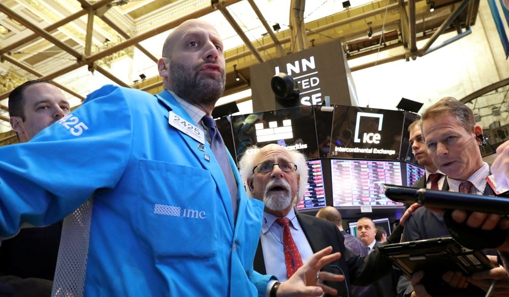 Traders work on the floor of the New York Stock Exchange. In switching to a dovish stance, some claim the Fed has “capitulated” to markets. Photo: Reuters