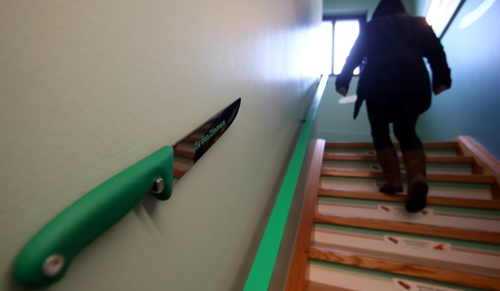 A butcher’s knife points the way to the upstairs rooms at the Bratwurst Hotel in Rittersbach, Germany. Photo: Reuters