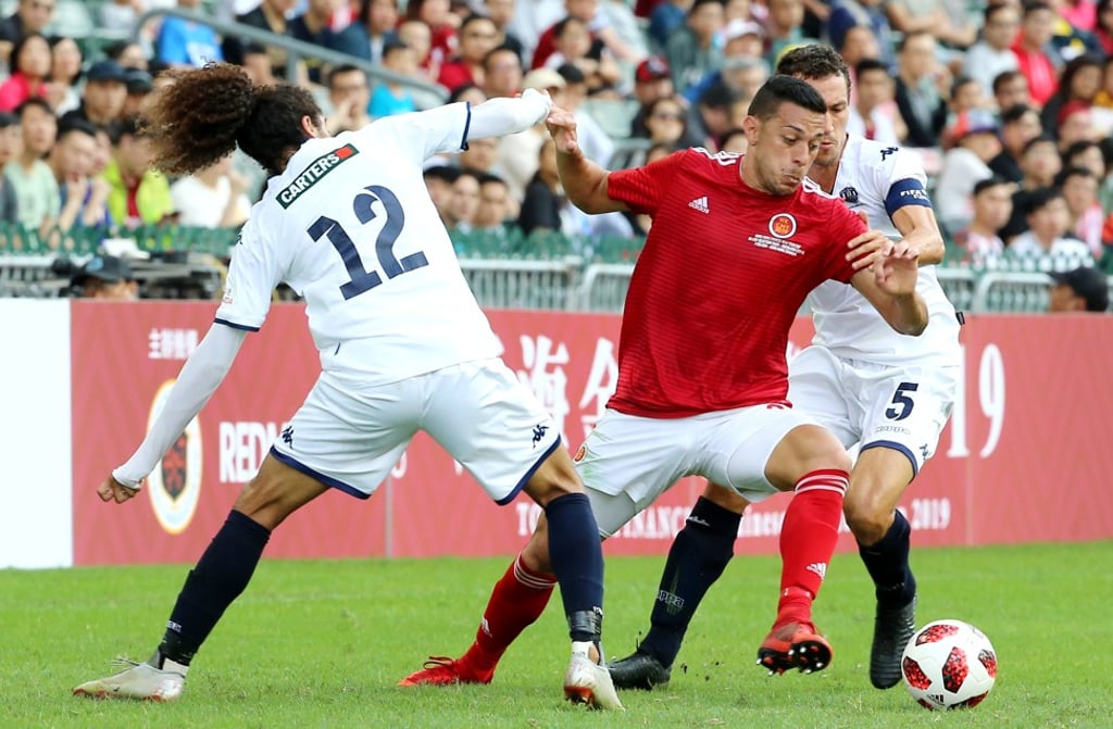 Hong Kong’s Paixao De Souza causes problems for the Auckland City defence.