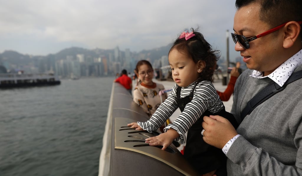 A child touches a movie star’s handprints at the newly redesigned Tsim Sha Tsui promenade. Photo: Sam Tsang