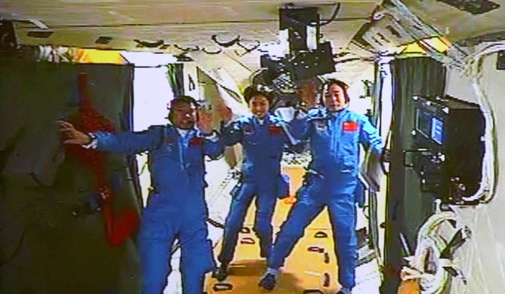 FILE - In this June 18, 2012, file image released by China's Xinhua News Agency, Chinese astronauts, from left, Liu Wang, Liu Yang and Jing Haipeng wave while aboard the orbiting Tiangong-1 space station. Photo: Xinhua