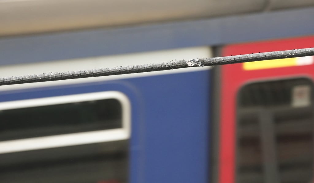 A power cable was damaged by the handrail that police believe may have been thrown onto the line deliberately. Photo: Felix Wong