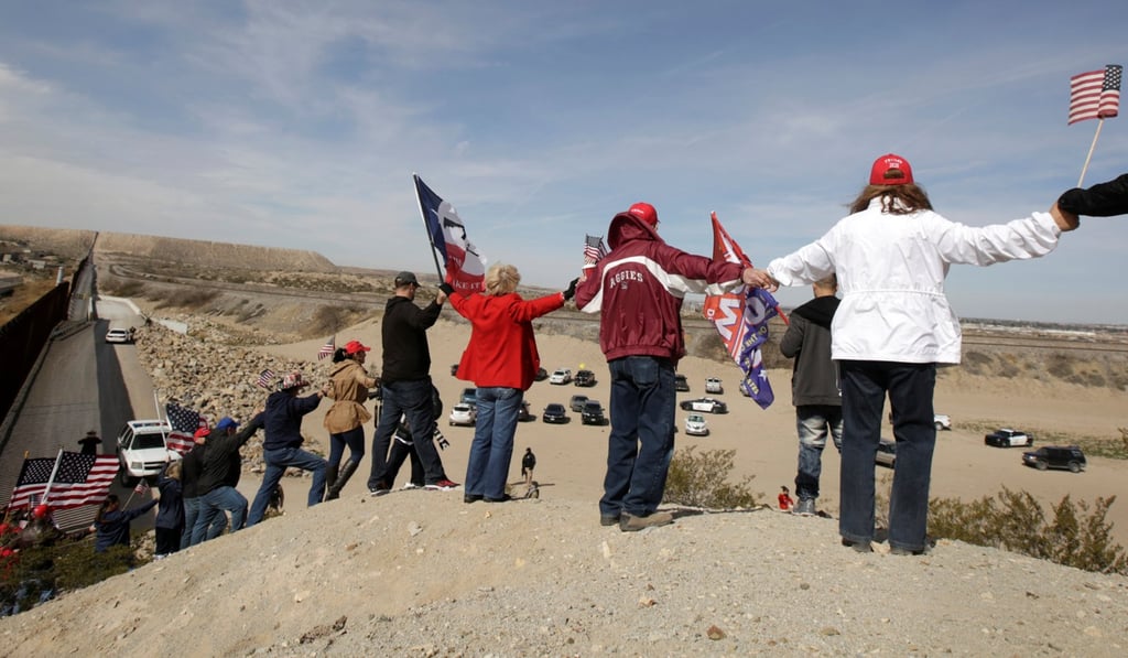 Demonstrators hold hands at the open border to make a human wall in support of the construction of a wall between US and Mexico on Saturday. Photo: Reuters