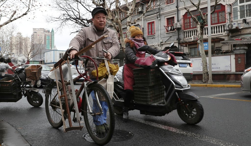 Ma Jiale cycles from job to job in a pocket of Shanghai’s Hongkou district. Photo: AFP