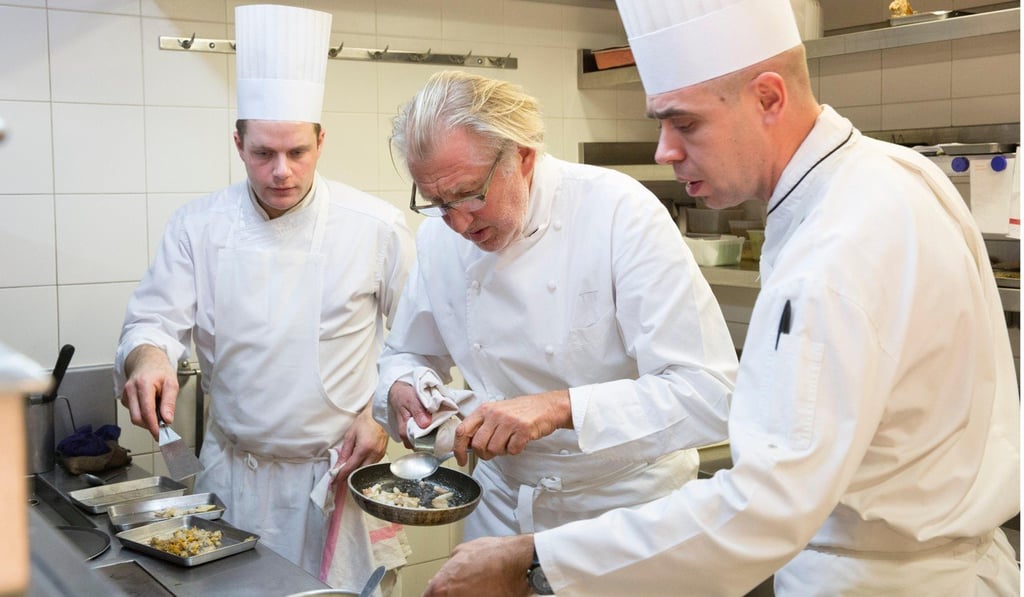 Pierre Gagnaire (centre) in his restaurant in Paris. Picture: Alamy