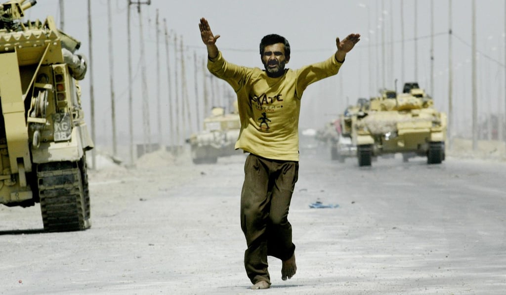 An Iraqi man greets British troops leaving the southern Iraqi city of Basra in April 2003. The US-led invasion of Iraq that toppled Saddam Hussein sought to enshrine a liberal democracy in the heart of the Middle East but instead unleashed brutal sectarian violence and endless political disputes. Photo: AFP