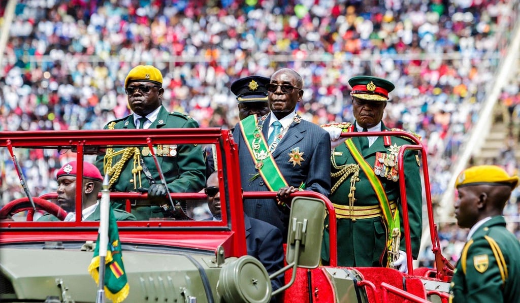 Robert Mugabe (centre), then president of Zimbabwe, reviews a guard of honour during the country’s 37th Independence Day celebrations in Harare on April 18, 2017. Mugabe counted on the support of the military to sustain his rule, which was marked by corruption. Photo: AFP