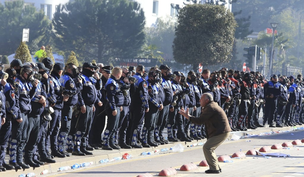 An opposition supporter shouts at police officers during an anti-government rally outside the prime minister's office in the capital Tirana. Photo: AP Photo An opposition supporter shouts at police officers during an anti-government rally outside the prime minister's office in the capital Tirana. Photo: AP Photo