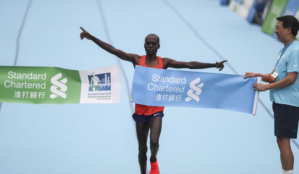 Kenya’s Barnabus Kiptum breaks the course record for the men’s marathon at the finish line in Victoria Park. Photo: Nora Tam